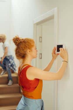 woman_red_hair_using_thermostat